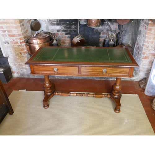 713 - A VICTORIAN MAHOGANY WRITING TABLE
With green tooled leather top above two drawers, raised on two co... 