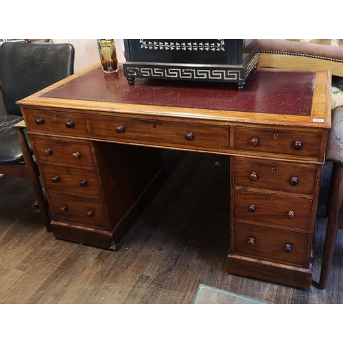 719 - A VICTORIAN MAHOGANY TWIN PEDESTAL DESK
With maroon told leather surface above an arrangement of nin... 