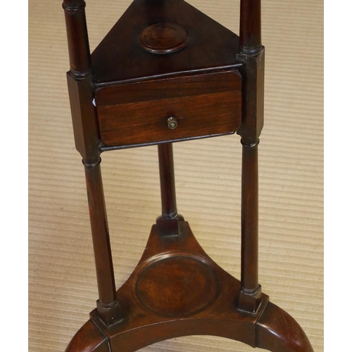 727 - A 19TH CENTURY MAHOGANY SHAVING STAND
The circular dish top above a single drawer, raised on three c... 