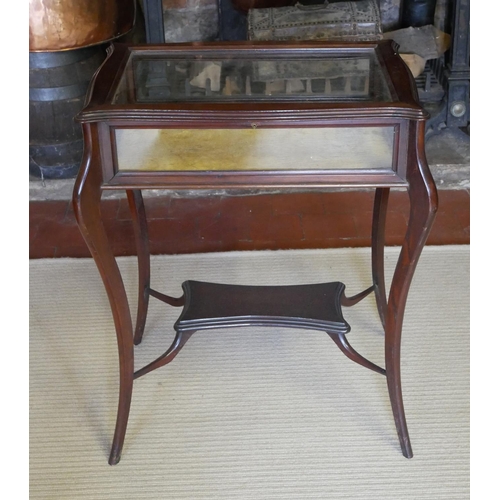 728 - A LATE VICTORIAN MAHOGANY BIJOUTERIE TABLE
With cartouche shaped top glazed top enclosing a velvet l... 