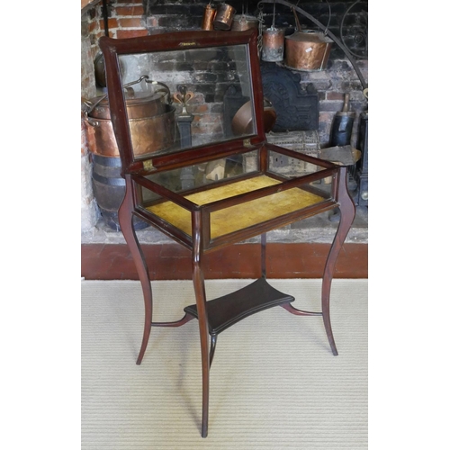 728 - A LATE VICTORIAN MAHOGANY BIJOUTERIE TABLE
With cartouche shaped top glazed top enclosing a velvet l... 