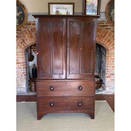 735 - A VICTORIAN MAHOGANY LINEN PRESS
The two panelled doors enclosing slides above two drawers, raised o... 