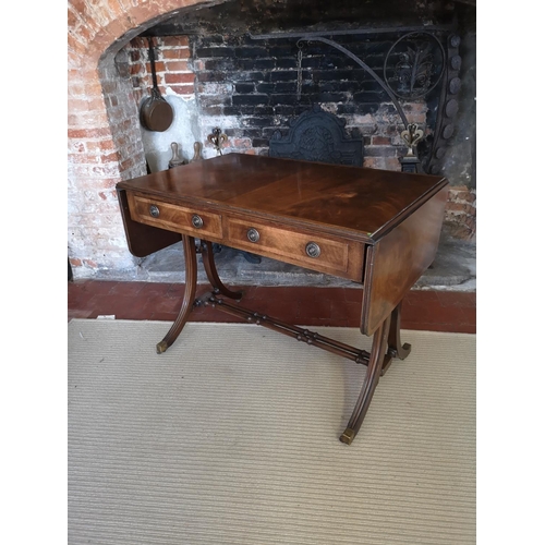 736 - A REGENCY STYLE MAHOGANY SOFA TABLE
With real and false drawers, raised on splayed legs joined by ri... 