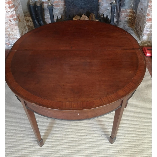 740 - A 19TH CENTURY MAHOGANY AND CROSSBANDED ‘D’ END DINING TABLE
With one extra leaf, raised on square t... 