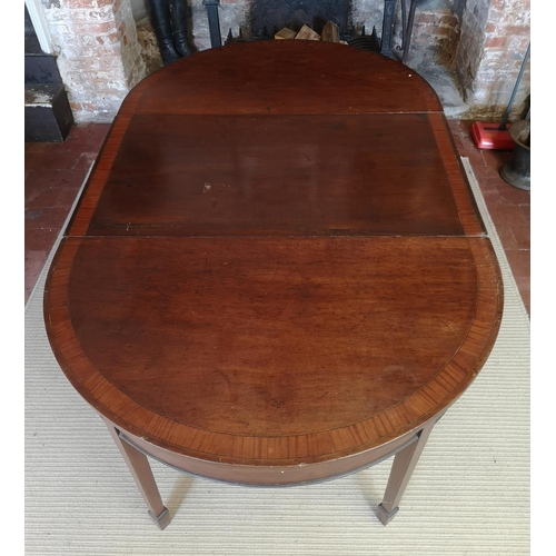 740 - A 19TH CENTURY MAHOGANY AND CROSSBANDED ‘D’ END DINING TABLE
With one extra leaf, raised on square t... 