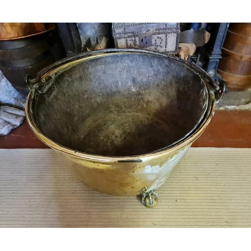 754 - A LARGE EARLY 19TH CENTURY BRASS LONG BIN
With iron strap work handle above circular body enclosing ... 