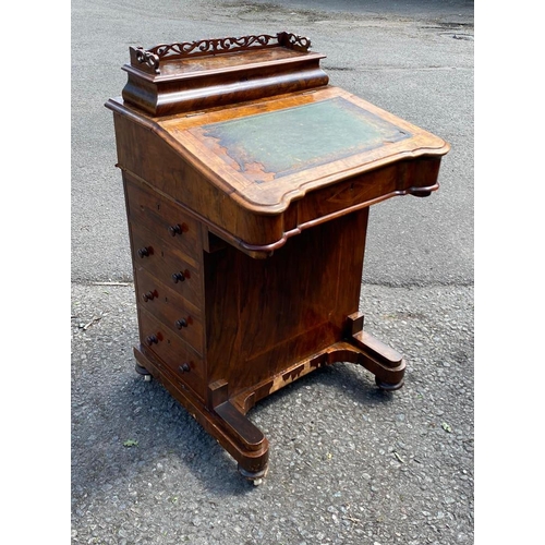 756 - A VICTORIAN WALNUT DAVENPORT DESK
With pierced galleried back above fitted writing section and side ... 