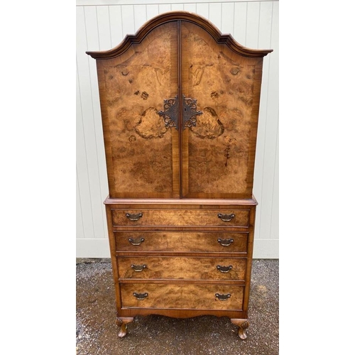 761 - AN EARLY 20TH CENTURY QUEEN ANNE REVIVAL FIGURED AND BURR WALNUT CABINET
The domed top above two oge... 