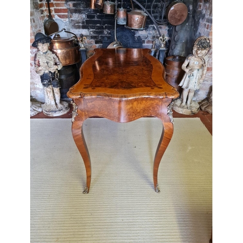 765 - A 19TH CENTURY FRENCH BURR AND FIGURED WALNUT MARQUETRY INLAID CENTRE TABLE
With ogee top above two ... 