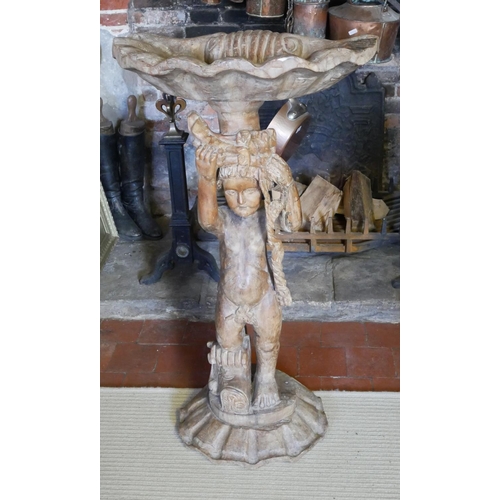 766 - AN ITALIAN INSPIRED CARVED WOODEN BIRD BATH
Shell held aloft by a putti.
(60cm x 110cm)

Condition: ... 