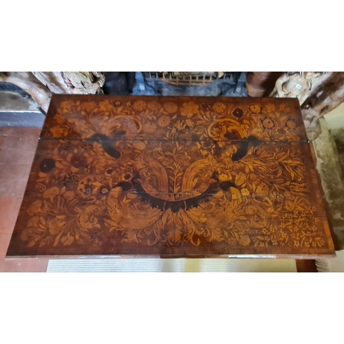 767 - AN 18TH CENTURY DUTCH WALNUT AND FLORAL MARQUETRY INLAID SIDE/WRITING TABLE
The rectangular top open... 