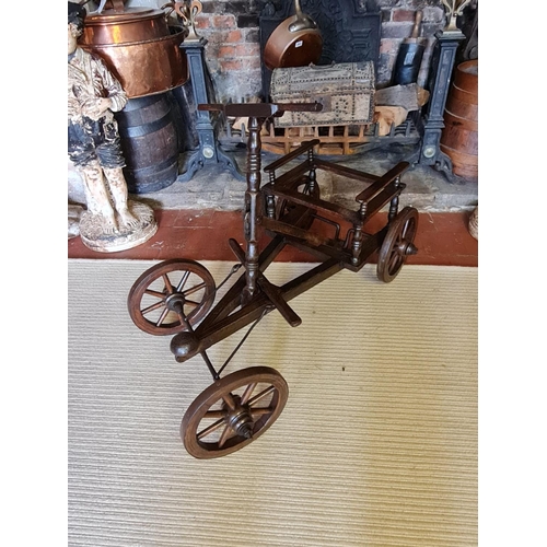 769 - A 19TH CENTURY FRENCH FRUITWOOD PULL ALONG CART
With foot steering, iron bound spoked wheels.
(95cm ... 