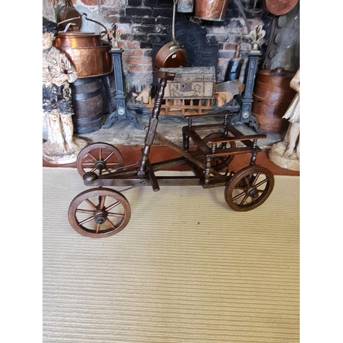 769 - A 19TH CENTURY FRENCH FRUITWOOD PULL ALONG CART
With foot steering, iron bound spoked wheels.
(95cm ... 