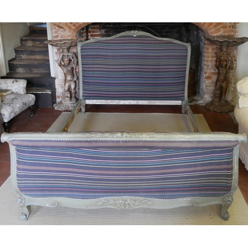 772 - A 19TH CENTURY FRENCH PAINTED WOODEN DOUBLE BED
The scrolled frame carved with floral decoration, th... 