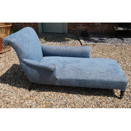 774 - A VICTORIAN DAYBED
With a single scroll arm and blue fabric upholstery, on ebonised legs. 
(approx 6... 