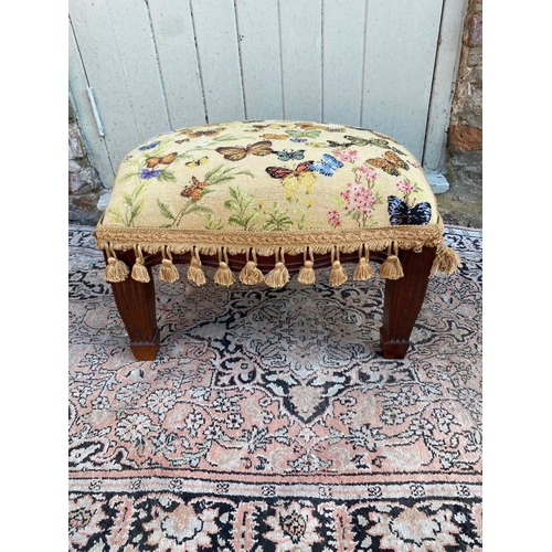 801 - A TAPESTRY UPHOLSTERED STOOL
Decorated with butterflies, on square tapering legs.
(46cm x 35cm x 29c... 