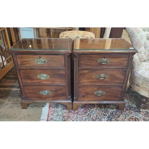 802 - A PAIR OF 19TH CENTURY MAHOGANY PEDESTAL CHESTS
Three rolls fitted with brass furniture flanked by t... 