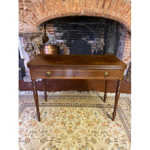 803 - A GEORGIAN MAHOGANY FOLD-OVER TEA TABLE
With a single drawer fitted with loop handles, raised on rin... 