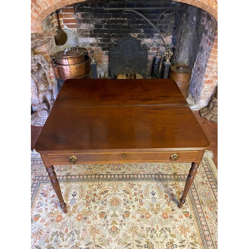 803 - A GEORGIAN MAHOGANY FOLD-OVER TEA TABLE
With a single drawer fitted with loop handles, raised on rin... 