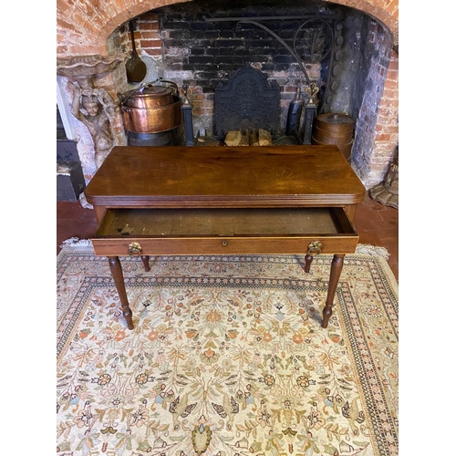 803 - A GEORGIAN MAHOGANY FOLD-OVER TEA TABLE
With a single drawer fitted with loop handles, raised on rin... 