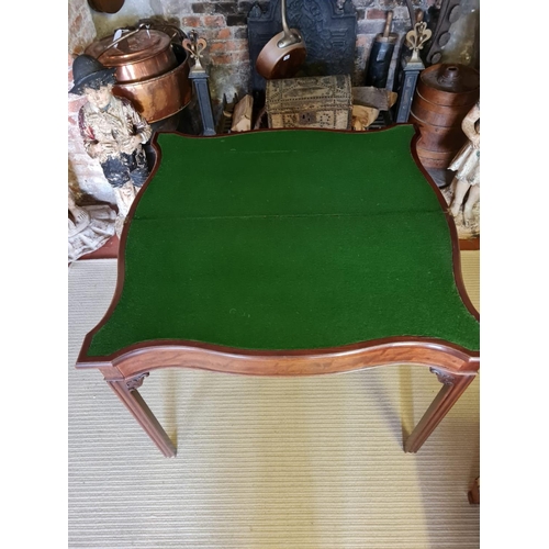 806 - A 18TH CENTURY MAHOGANY FOLD OVER CARD TABLE
Serpentine form with baize playing surface, on square c... 