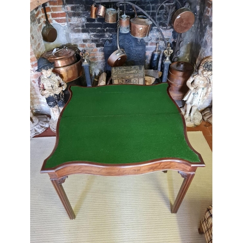 806 - A 18TH CENTURY MAHOGANY FOLD OVER CARD TABLE
Serpentine form with baize playing surface, on square c... 