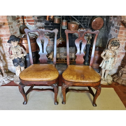 807 - A RARE PAIR OF EARLY/MID 18TH CENTURY IRISH WALNUT STRETCHER CHAIRS
With shaped rails centred with a... 