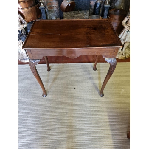 808 - AN 18TH CENTURY MAHOGANY SILVER TABLE
The dished top above a shaped apron, on cabriole legs with aca... 