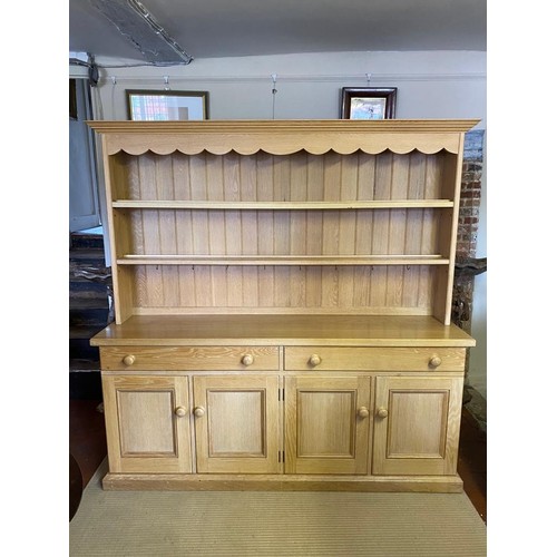 751 - A VICTORIAN STYLE LIMED OAK DRESSER
With open shelves above two long drawers and four cupboards, on ... 