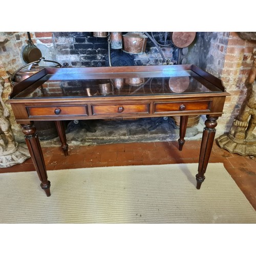 752 - A VICTORIAN MAHOGANY WRITING TABLE
With galleried back above three drawers, raised on turned fluted ... 