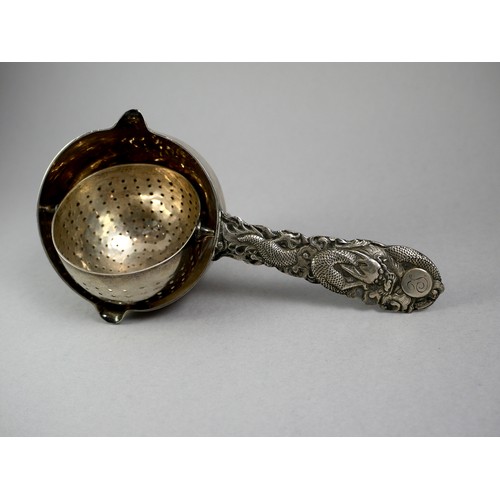 436 - A SILVER TRIPOD TEA STRAINER 
With fine dragon handle in low relief, marked ‘Tuck Chang’, along with... 