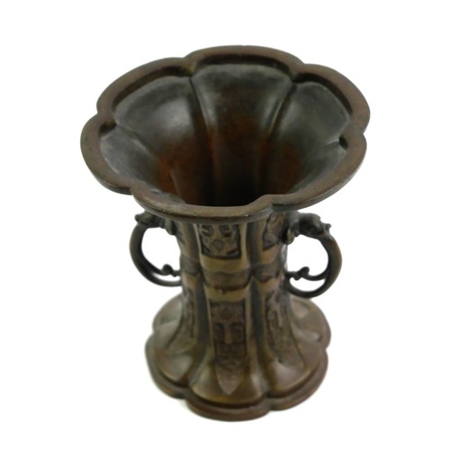 140 - A LATE 19TH/EARLY 20TH CENTURY CHINESE EXPORT BRONZE TWIN HANDLED ‘GU’ FORM VASE/RITUAL VESSEL
Decor... 