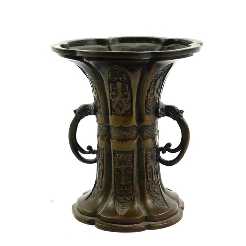 140 - A LATE 19TH/EARLY 20TH CENTURY CHINESE EXPORT BRONZE TWIN HANDLED ‘GU’ FORM VASE/RITUAL VESSEL
Decor... 