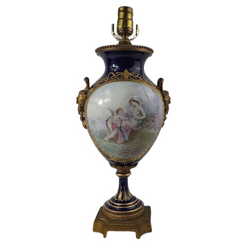 38 - A FRENCH PORCELAIN TABLE LAMP 
With decorated panels on midnight blue ground.
(h 46cm)

Condition: g... 