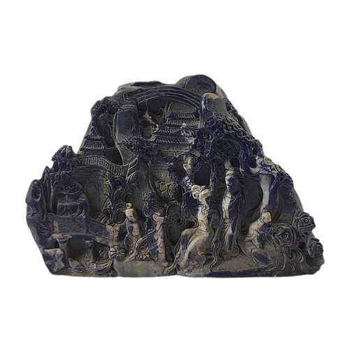 25 - A CARVED LAPIS LAZULI COBBLE 
Depicting a Chinese gathering in relief.
(h 14cm x length 20cm)

Condi... 
