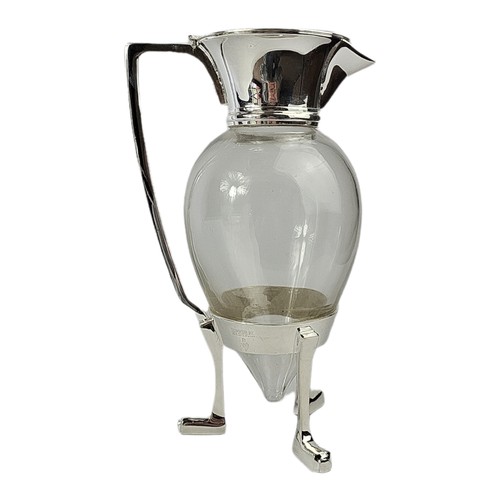 12 - A CHRISTOPHER DRESSER DESIGN SILVER PLATE AND GLASS CLARET JUG.
(25cm)

Condition: good