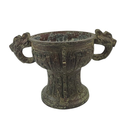 5 - A CHINESE ARCHAIC STYLE BRONZE TWO HANDLED CENSER
Decorated with Chinese symbols.
(h 20cm x 19cm)

C... 