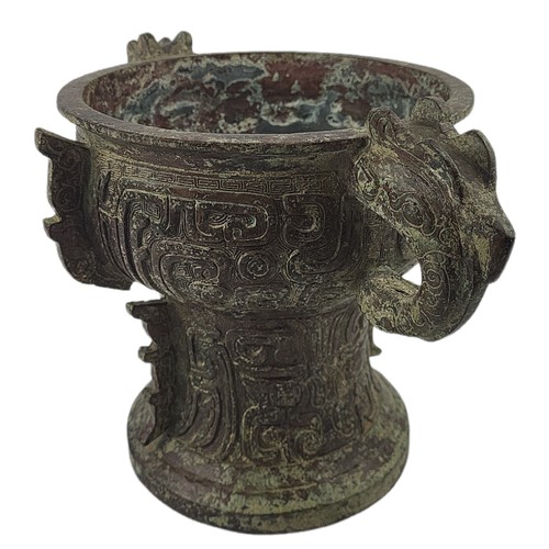 5 - A CHINESE ARCHAIC STYLE BRONZE TWO HANDLED CENSER
Decorated with Chinese symbols.
(h 20cm x 19cm)

C... 