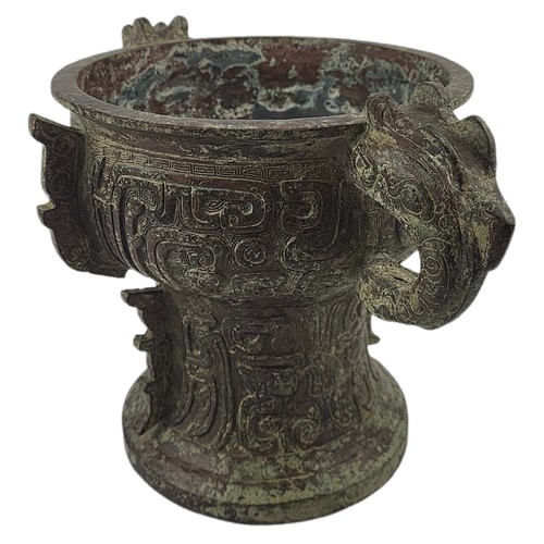 5 - A CHINESE ARCHAIC STYLE BRONZE TWO HANDLED CENSER
Decorated with Chinese symbols.
(h 20cm x 19cm)

C... 