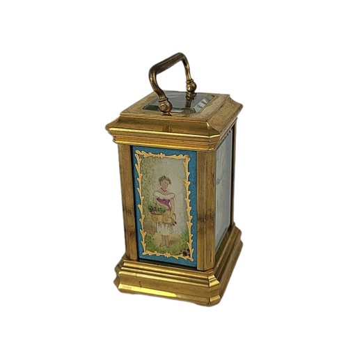 84 - A MINIATURE SÈVRES STYLE FRENCH PORCELAIN AND POLISHED BRASS CARRIAGE CLOCK 
Having a glass top and ... 