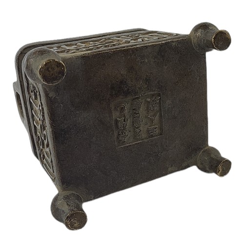 87 - AN ARCHAIC STYLE BRONZE CHINESE RECTANGULAR VESSEL
Twin handled, applied with Chinese calligraphy de... 