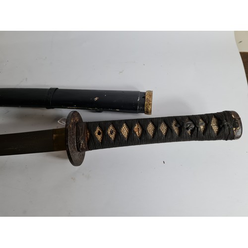 100 - A JAPANESE GUNTO SWORD
Bronze mounts, ebonised wood scabbard.
(length 96cm)

Condition: good, light ... 