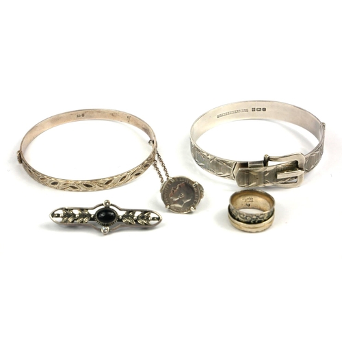 48 - A VINTAGE SILVER BELT BANGLE 
Together with another silver bangle, two silver rings and a silver bro... 