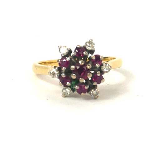 77 - A VINTAGE 18CT GOLD, RUBY AND DIAMOND CLUSTER RING
Having an arrangement of round cut rubies edged w... 