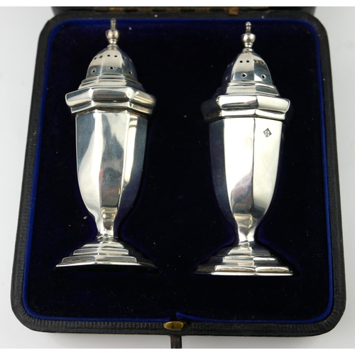 10 - A PAIR OF EDWARDIAN SILVER PEPPERETTES
Classical urn form with facets, pierced lid and facets to bod... 