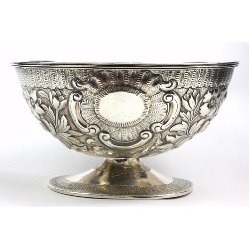 20 - A GEORGIAN IRISH SILVER OVAL SUGAR BASIN
With embossed floral decoration and cartouche, on a pedesta... 