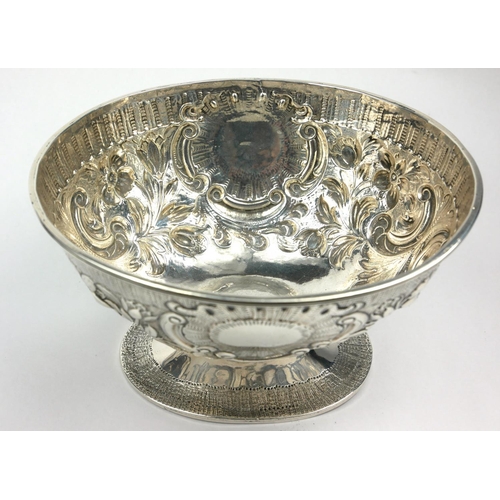 20 - A GEORGIAN IRISH SILVER OVAL SUGAR BASIN
With embossed floral decoration and cartouche, on a pedesta... 
