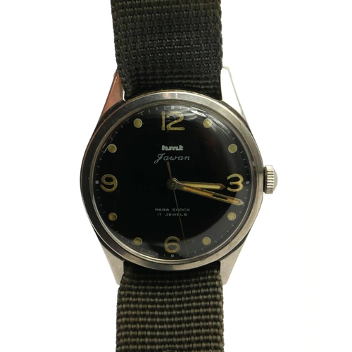 25 - HMT JAWAN, A VINTAGE STAINLESS STEEL MILITARY ISSUE GENT’S WRISTWATCH
Having a circular black dial w... 