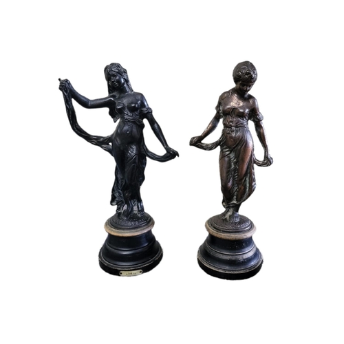 25A - A PAIR OF EARLY 20TH CENTURY CAST IRON STATUES
Classical form maidens, titled 'Modestie and Gaietie'... 