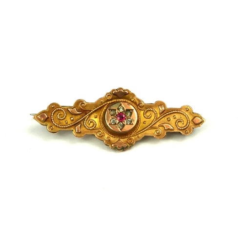3 - AN EARLY 20TH CENTURY 9CT GOLD, DIAMOND AND RUBY BROOCH
Scrolled decoration set with a central ruby ... 